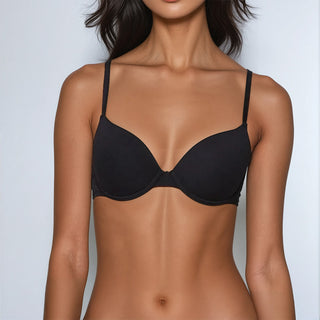 Black bra worn by a model against a plain background