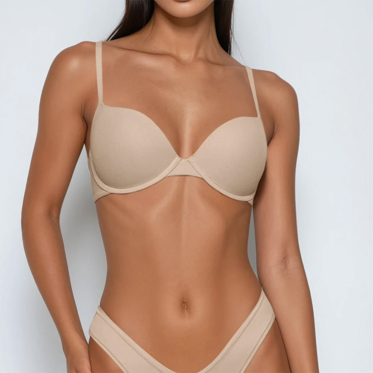 Beige bra and panties set on a plain background