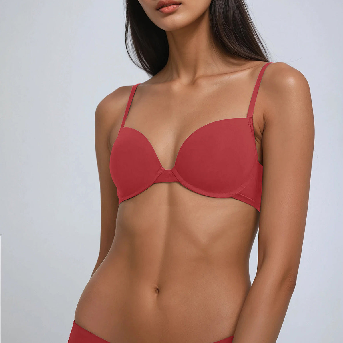 Red bra worn by a model on a white background