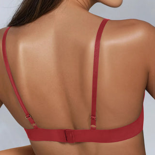 Red bra with thin straps on a plain background