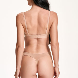 Beige lingerie set on a white background