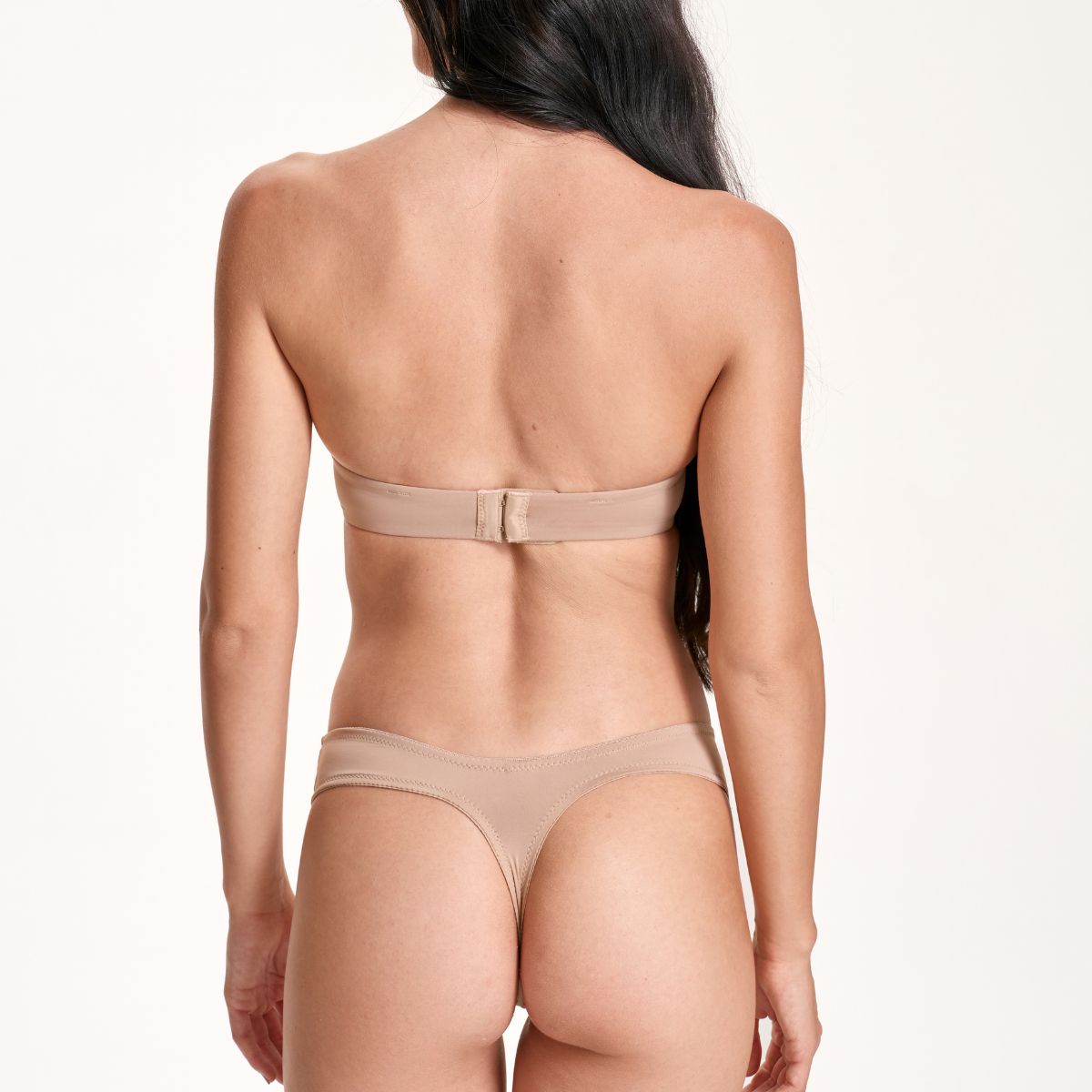 Beige bikini set worn by a model on a white background