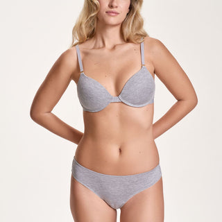 Woman wearing a gray bra and underwear set on a white background