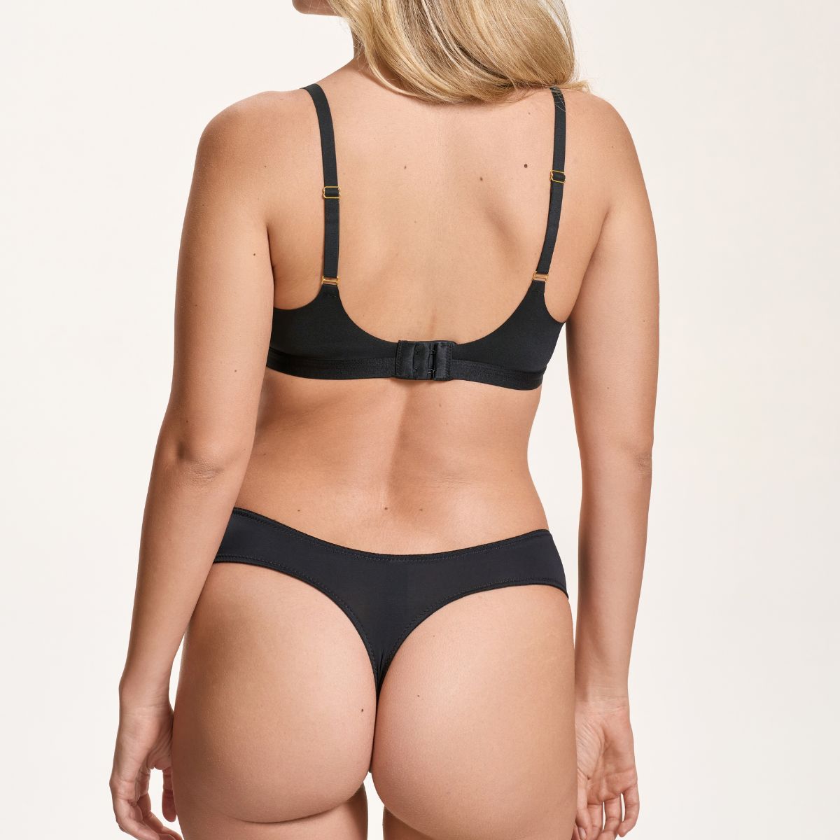 Black bikini set on a beige background