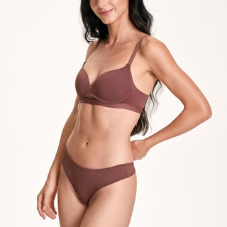 Woman wearing a brown bikini set on a white background