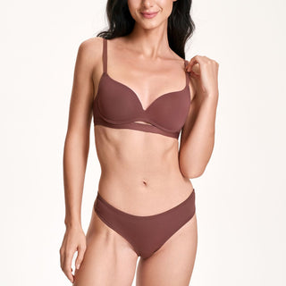 Woman wearing a brown bikini set on a white background