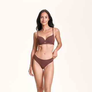 Woman wearing a brown bikini set on a white background