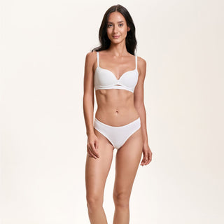 Woman wearing a white bikini on a plain background