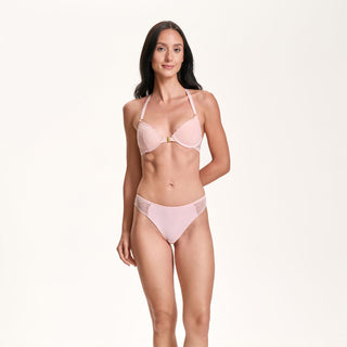 Woman wearing a pink bikini set on a white background