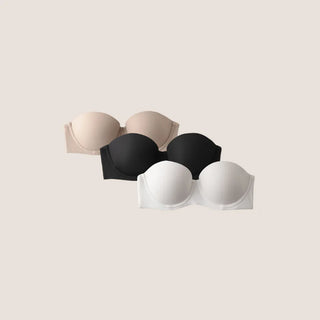 A set of three strapless push-up bras in beige, black, and white colors, displayed against a neutral background.