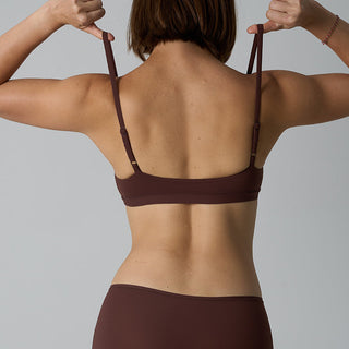 Person wearing a brown bikini against a gray background