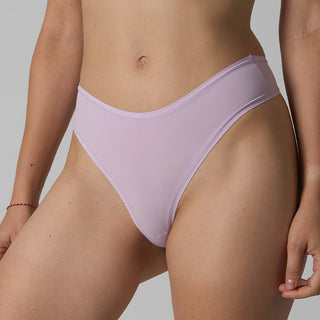 Person wearing light purple underwear against a neutral background