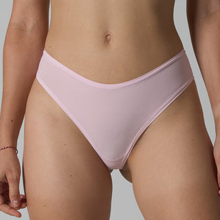 Person wearing light pink bikini bottoms on a neutral background
