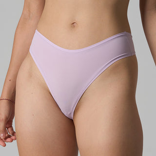 Lavender bikini bottom worn by a person on a gray background