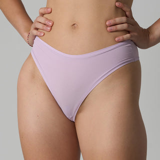Person wearing light purple bikini bottoms against a neutral background