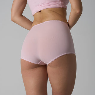 Person wearing pink high-waisted underwear and top on a gray background
