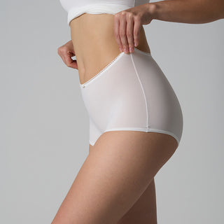 White shapewear being worn by a person on a gray background