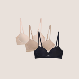 A set of three wireless push-up bras in beige, black, and a neutral color, displayed frontally against a light background.