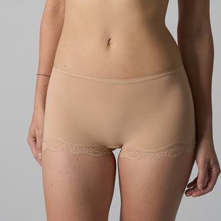 Beige lace-trimmed underwear on a gray background