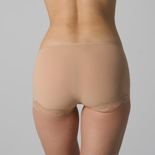 Beige lace-trimmed underwear on a gray background