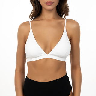 Woman wearing a white bikini top on a white background