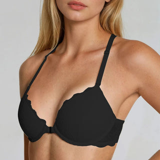 Black bra worn by a model on a plain background