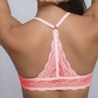 Pink lace lingerie set on a plain background